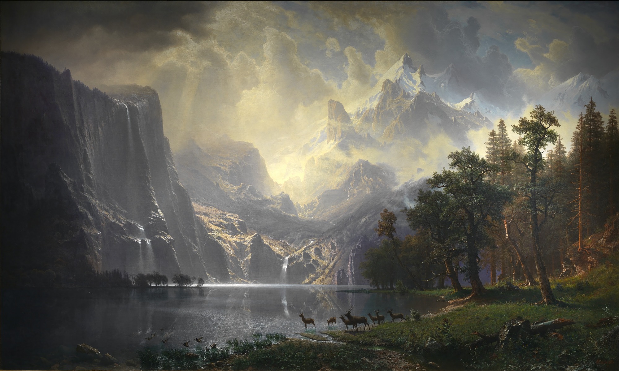 A luminous Sierra lake and mountain landscape painted by Albert Bierstadt